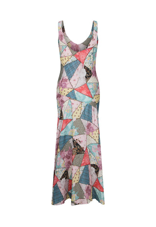 A sleeveless, scoop-neck maxi dress featuring a colorful geometric patchwork print with triangles and irregular shapes in pink, blue, yellow, and gray, shown against a plain white background.