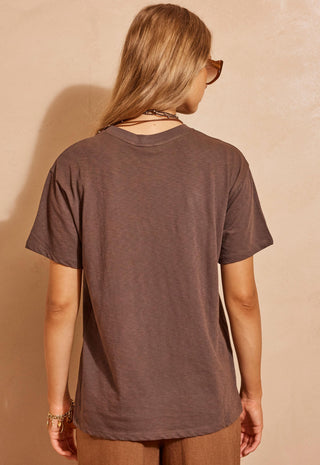  paired with brown wide-leg pants and sunglasses