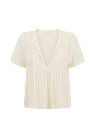 an-off-white-short-sleeve-blouse-with-a-deep-v-neckline-tie-details-at-the-collar-and-a-gathered-waist-shown-against-a-plain-white-background
